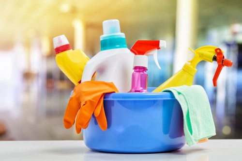 Cleaner wearing PPE while carrying out carpet cleaning indoors